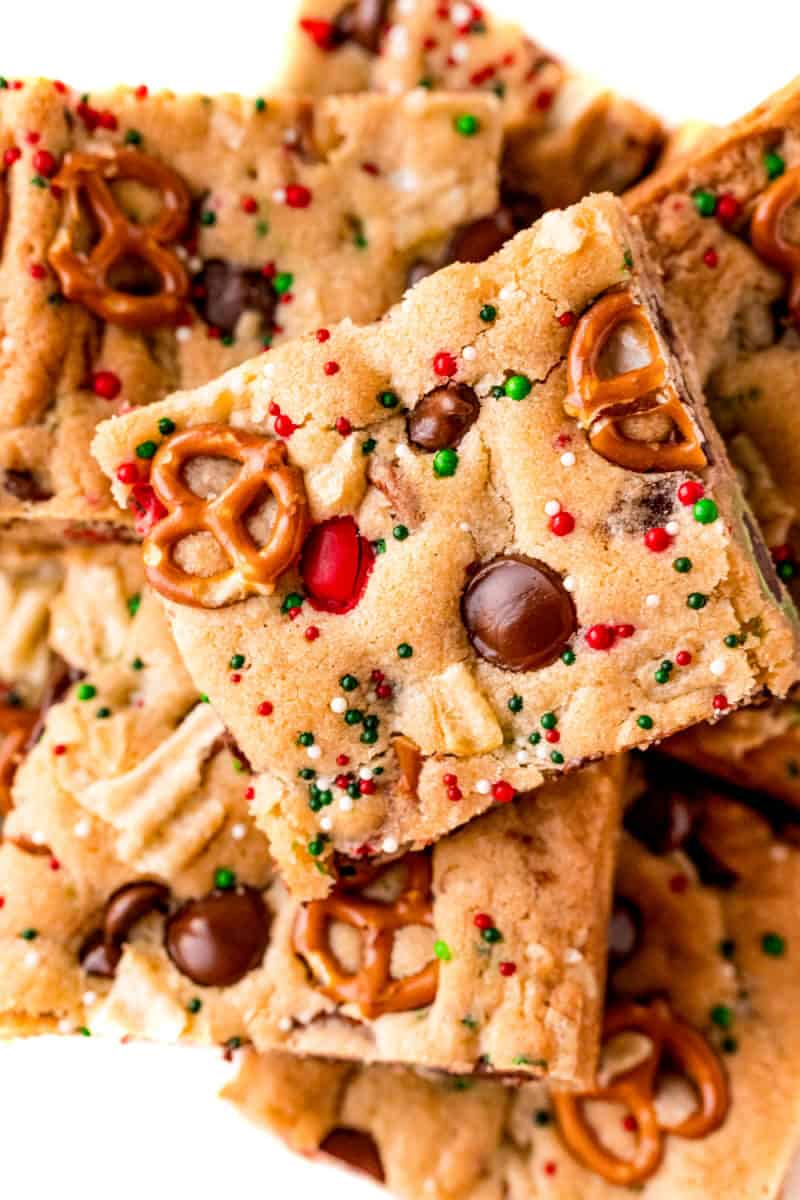 close up of santa's trash cookie bar on a pile of bars