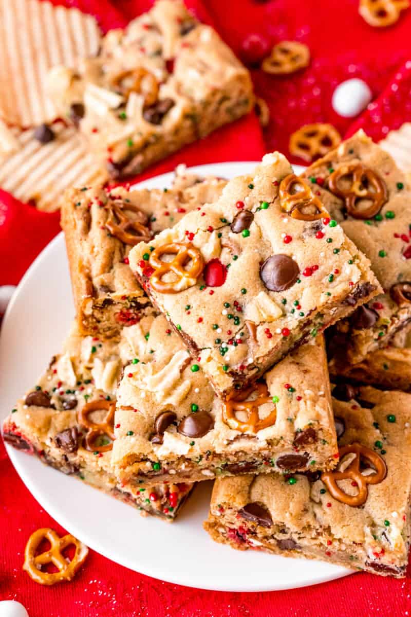 santa's trash cookie bars piled up on a white plate