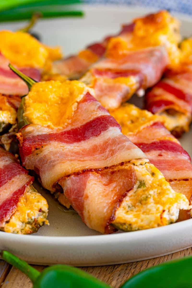 close up of a bacon wrapped jalapeno popper on a plate