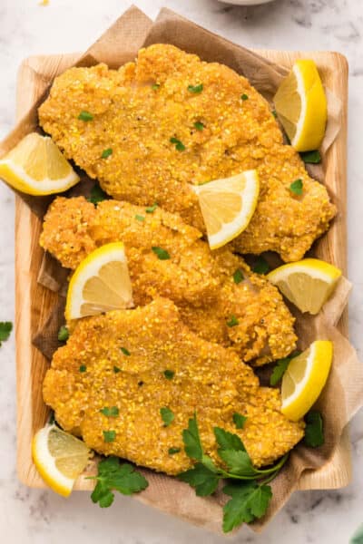 looking down at a tray of fried catfish with lemon wedges