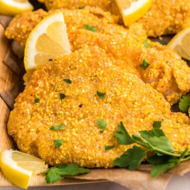 square image of fried catfish on a serving tray with lemons
