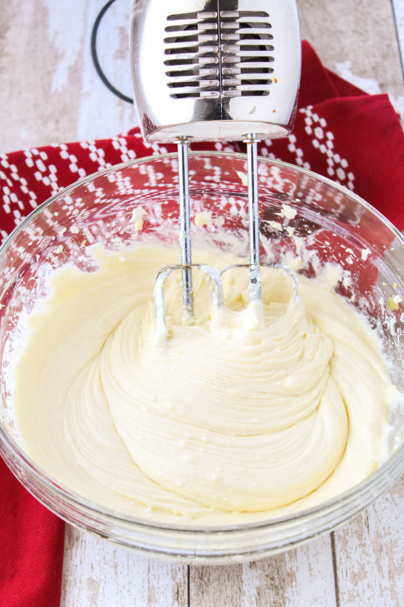 cheesecake filling mixed together in a bowl with a hand mixer