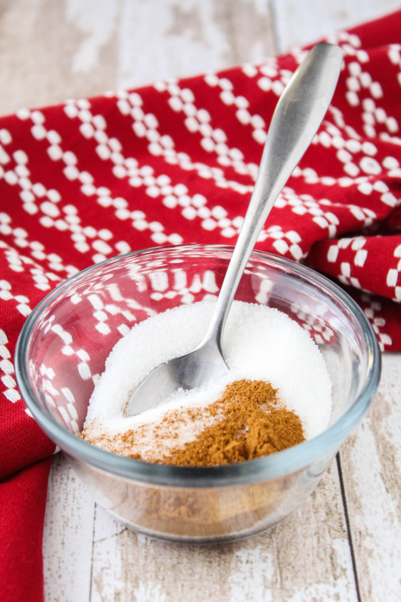 ground cinnamon and sugar in a small bowl with a spoon