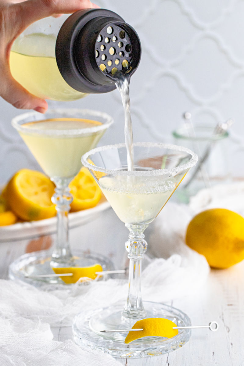lemon drop being poured into a sugar rimmed martini glass