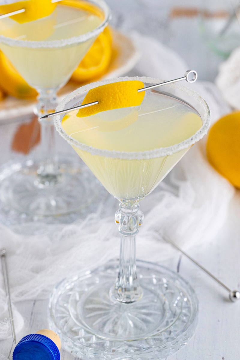 close up of a lemon drop martini with a lemon peel garnish