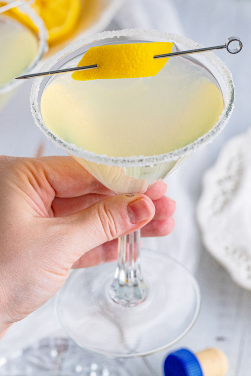 hand holding a lemon drop martini