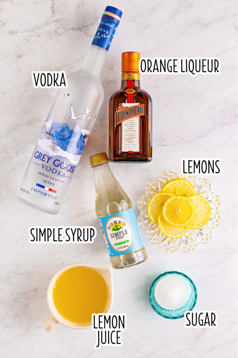 ingredients to make a lemon drop laid out on a counter with text labels