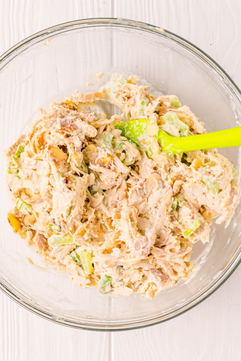chicken salad ingredients in a mixing bowl after being stirred