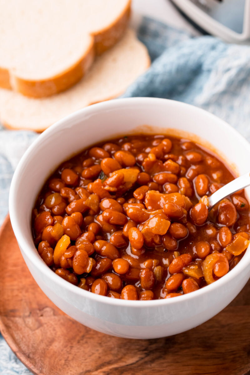 spoonful of crockpot baked beans over the bowl