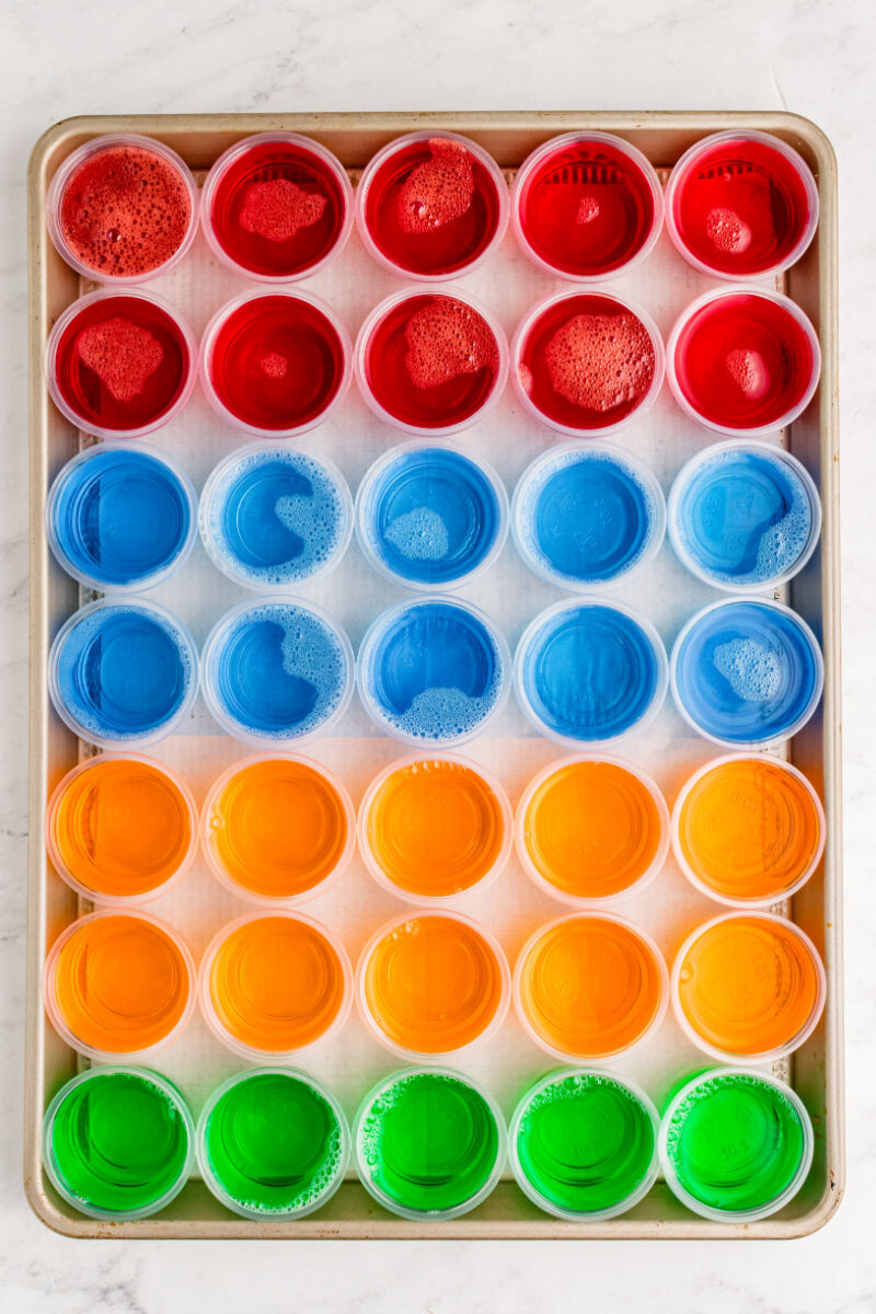 baking sheet of cherry, blue berry, orange, and lime jello shots