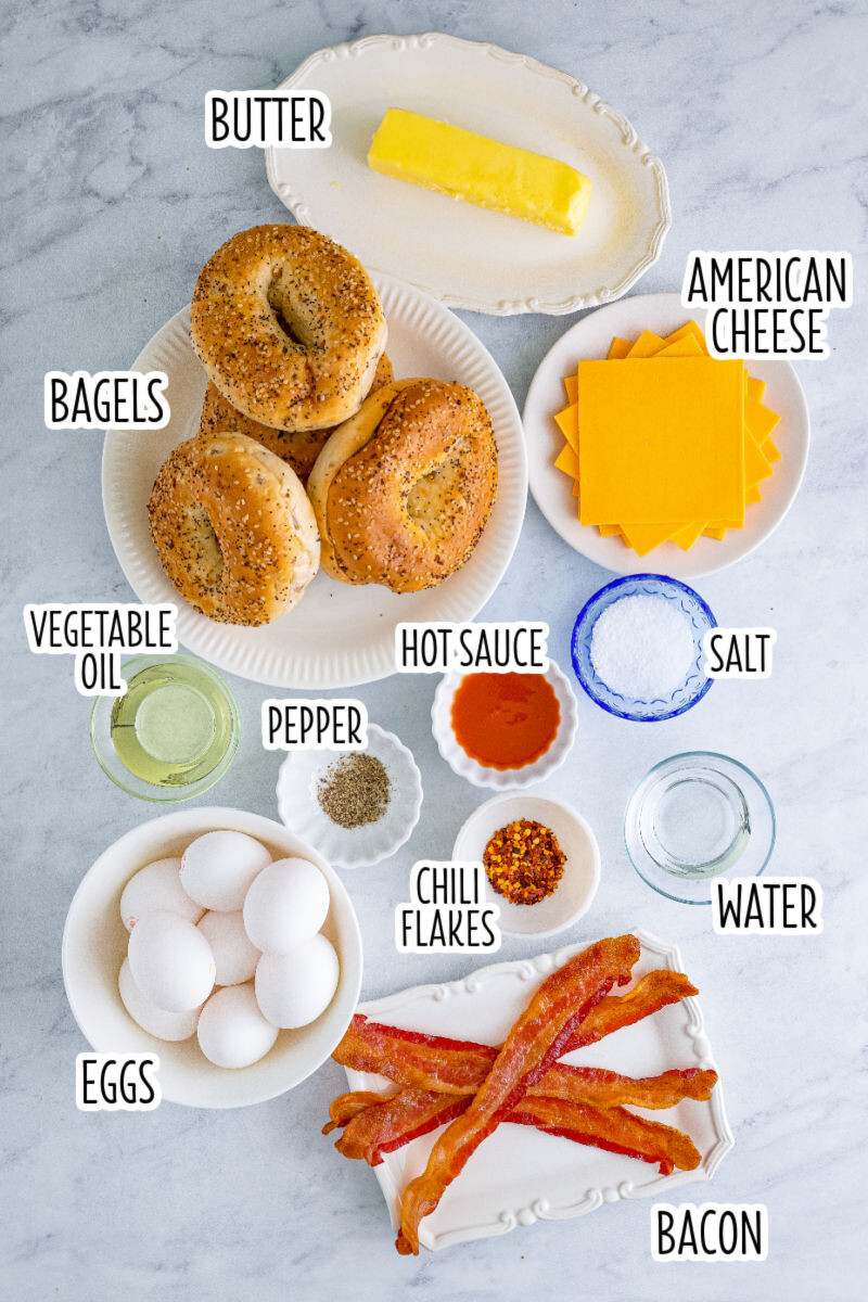 ingredients to make bacon, egg & cheese bagel breakfast sandwiches with text labels