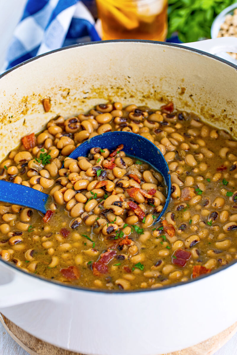 ladle in a pot of bacon black eyed peas