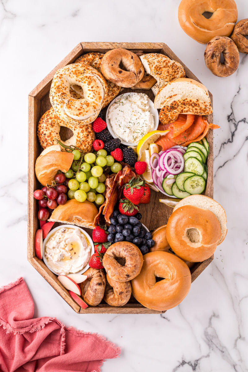 lox toppings, berries, grapes, and bacon added to a bagel board