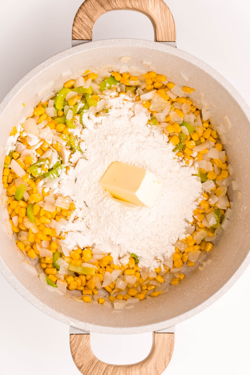 butter and flour added to corn and veggies in a large pot