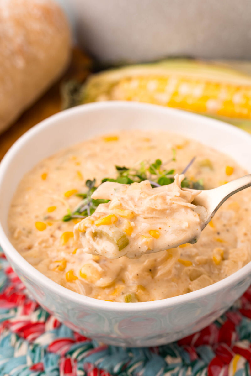 spoonful of chicken corn chowder over the bowl