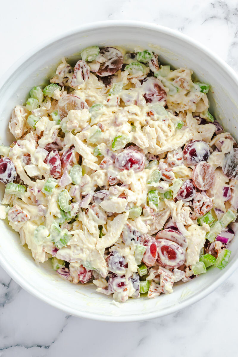 chicken salad with grapes in a mixing bowl after chilling in the fridge
