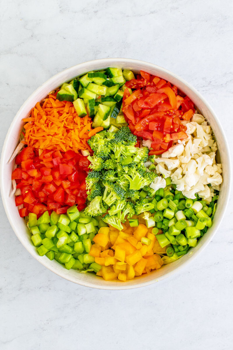 chopped salad vegetables arranged in a large bowl