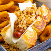 square image of a Copycat Dog Haus Chili the Kid with onion rings on a tray