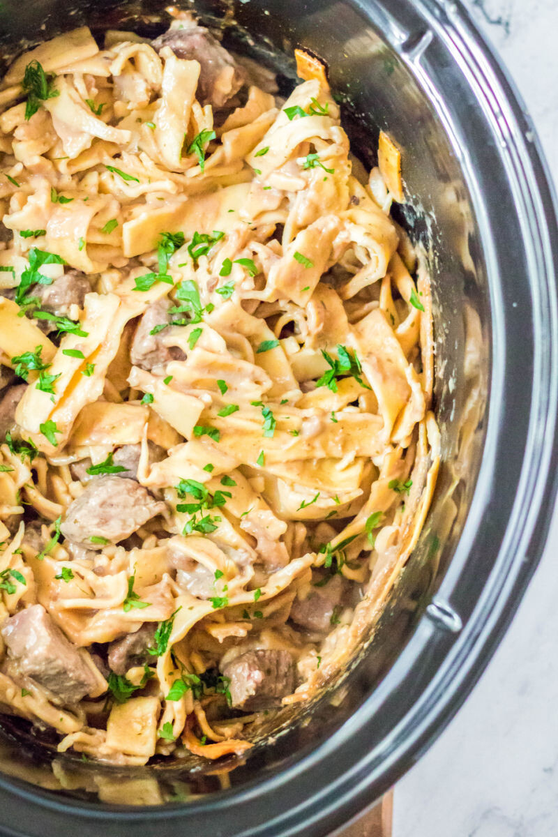 close up of crock pot beef and noodles in the slow cooker