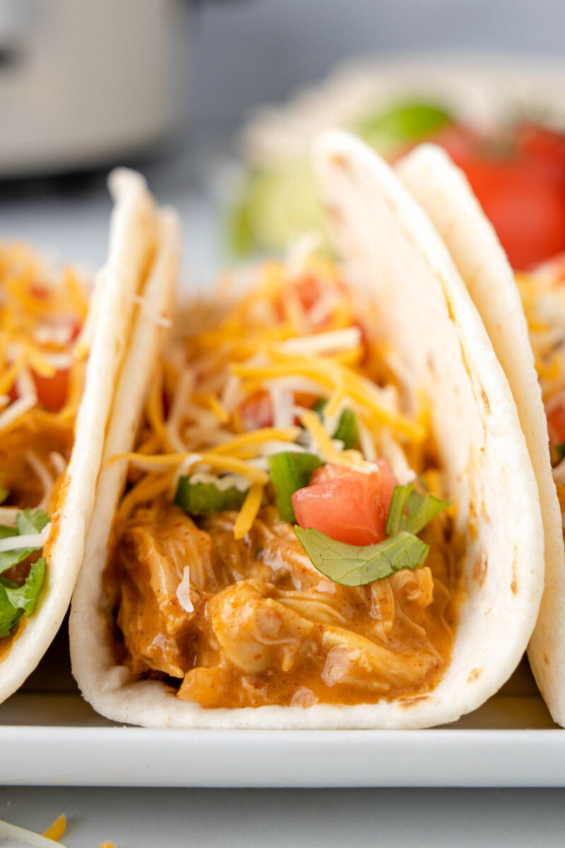 close up of crock pot queso chicken tacos on a plate