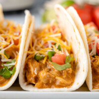 square image of crock pot queso chicken tacos