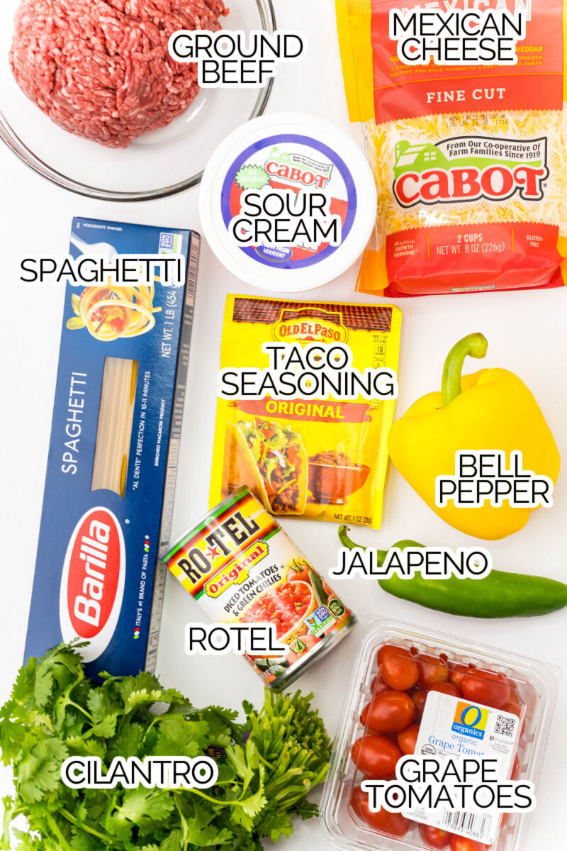 ingredients to make taco spaghetti on a counter with text labels