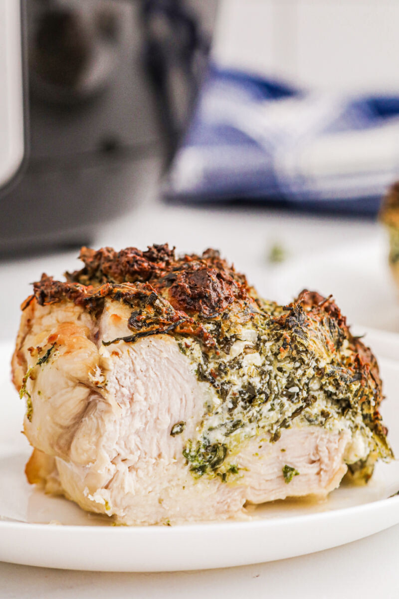 air fryer spinach & feta stuffed chicken breast with a portion cut off to show the filling