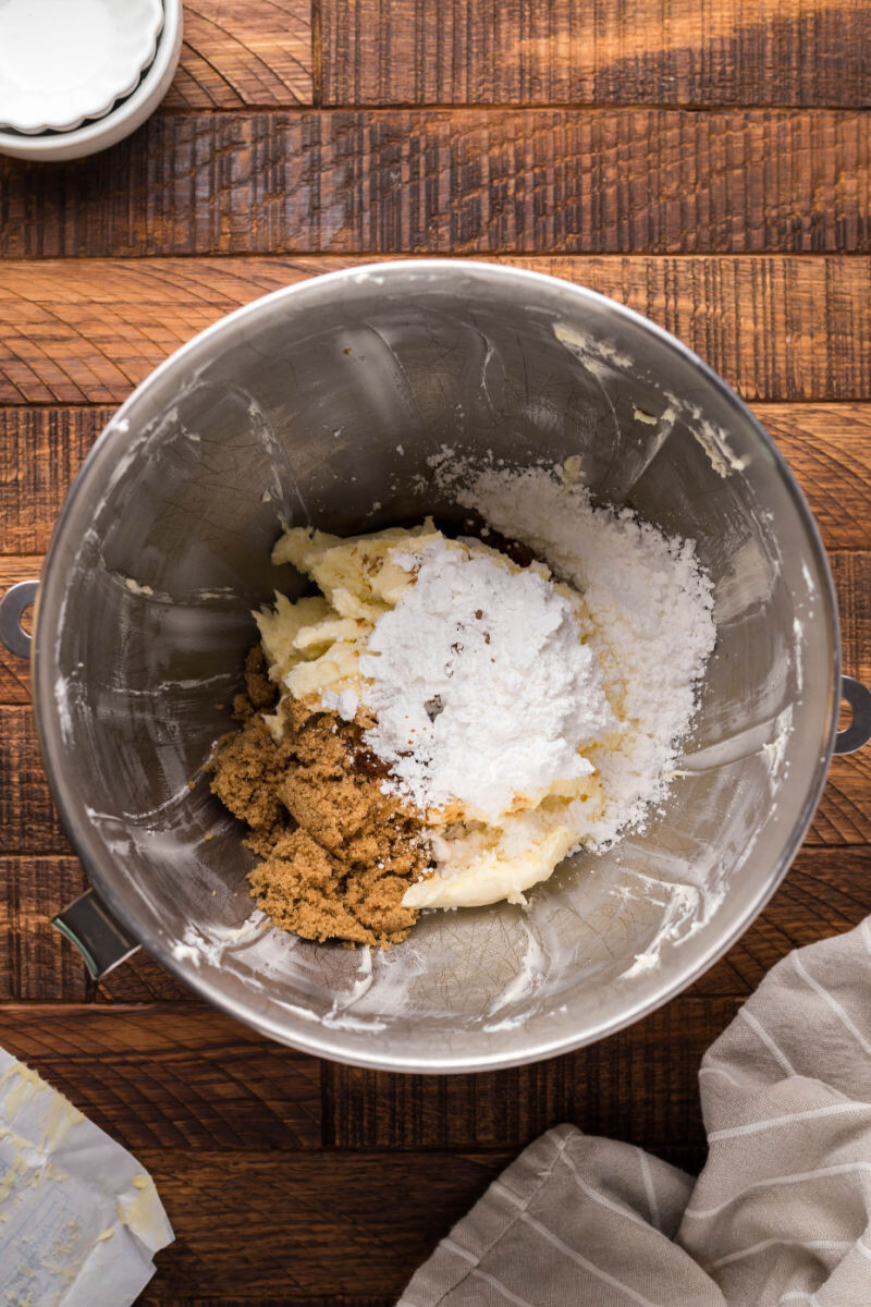 cream cheese, butter, powdered sugar, brown sugar, vanilla extract, and maple extract in a stand mixer bowl