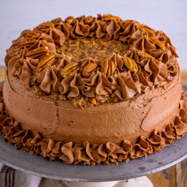 square image of a german chocolate cake on a cake stand