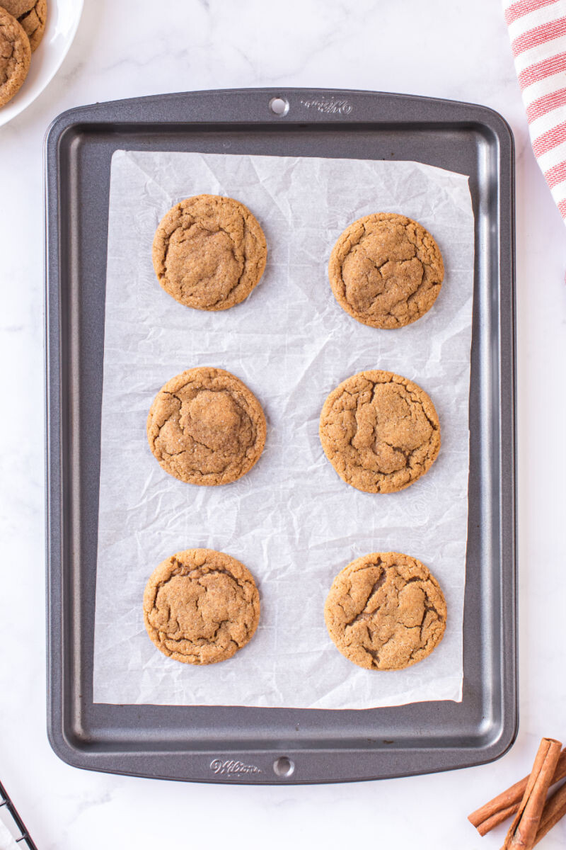 looking down at baked molasses cookies on a baking sheet