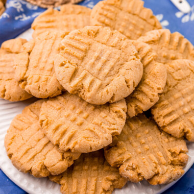 square image of peanut butter cookies piled on a plate