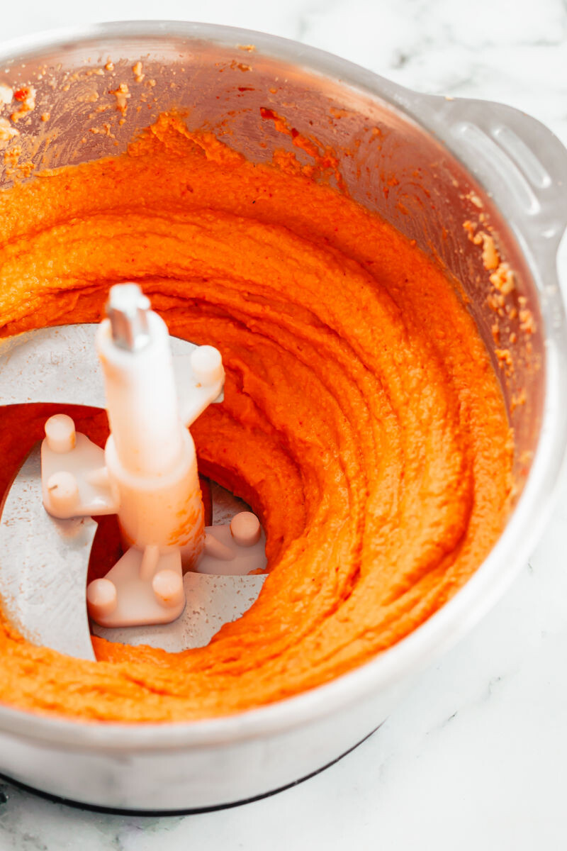 roasted red pepper hummus in a food processor bowl after being pureed