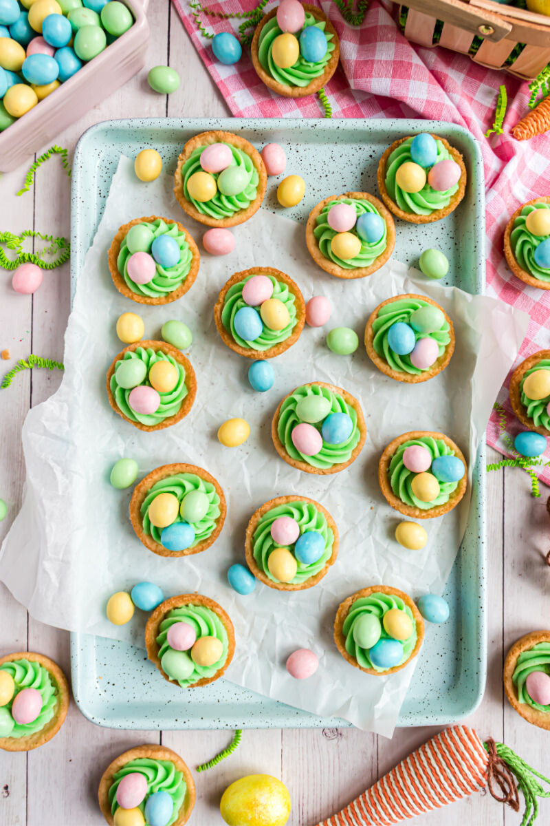 looking down at easter egg sugar cookie cups on a tray with parchment paper