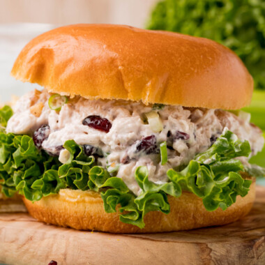 square image of a walnut & cranberry chicken salad sandwich with lettuce