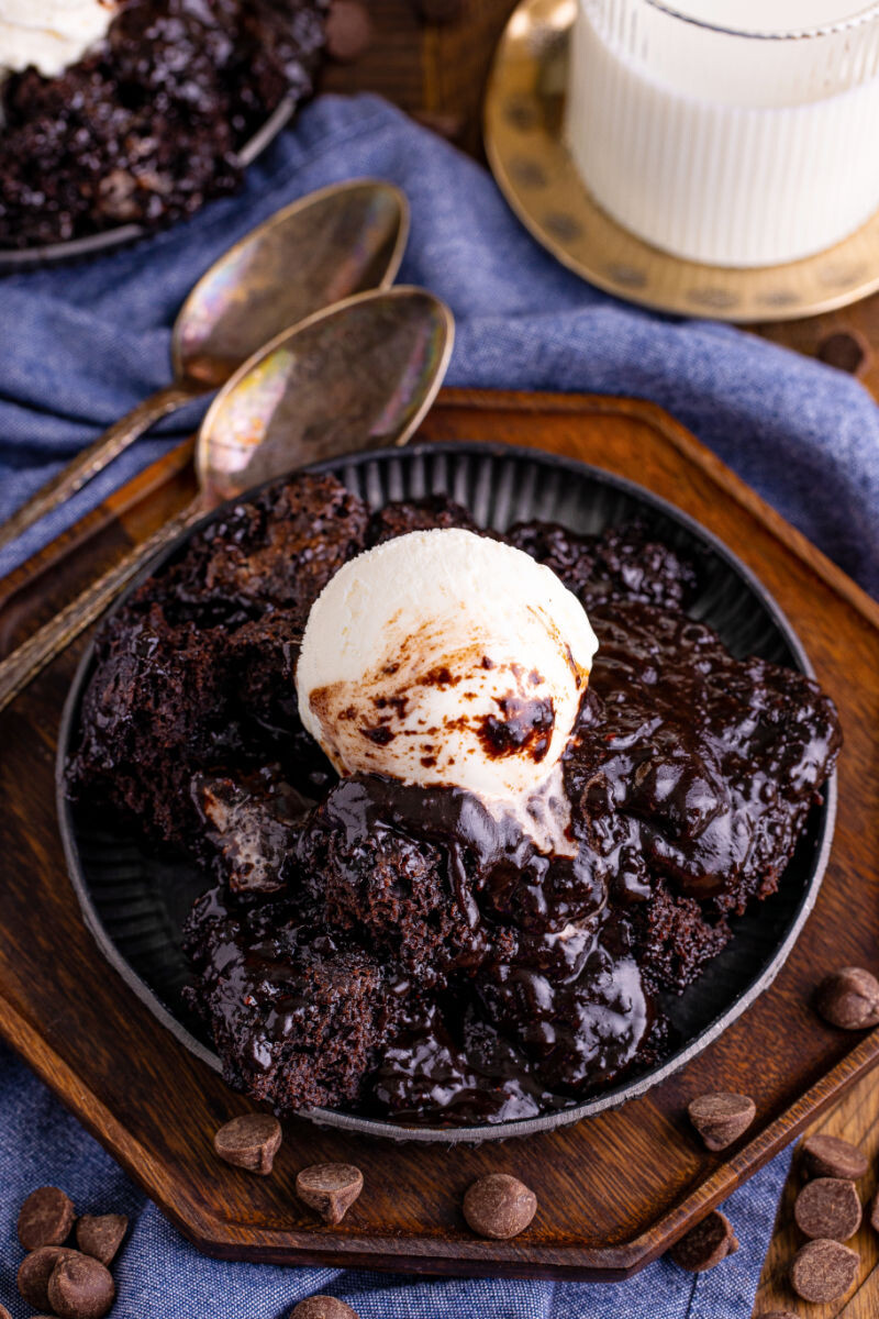 chocolate pudding cake on a plate with vanilla ice cream on top