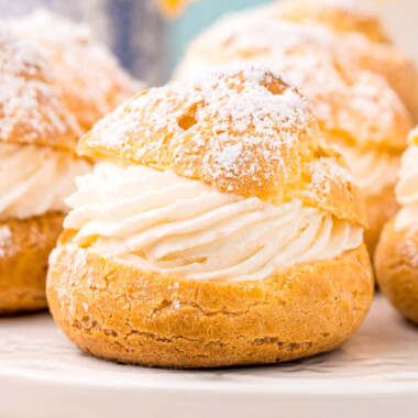 square image of cream puffs on a white serving plate