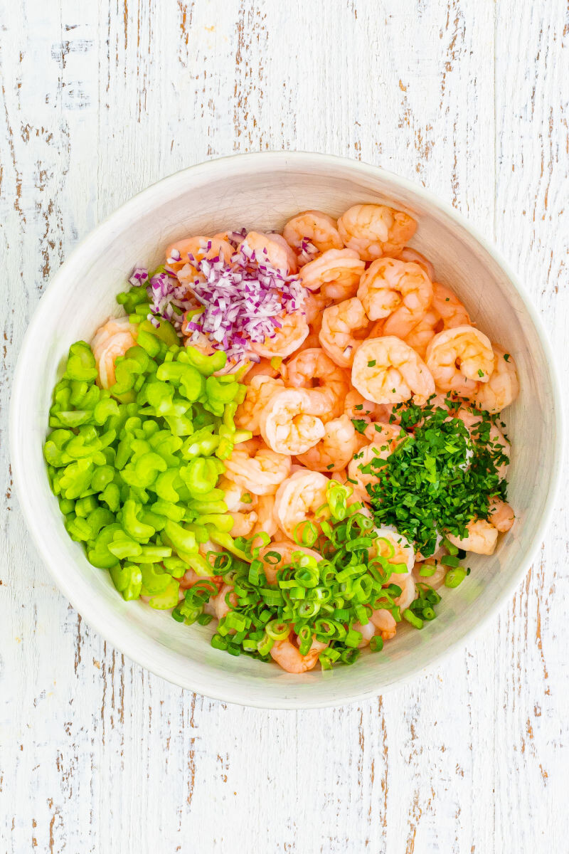 cooked shrimp, red onion, celery, green onion, and parsley in a large mixing bowl