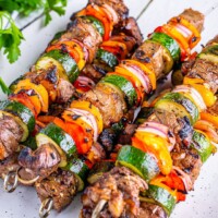 square image of balsamic steak kabobs piled on a platter