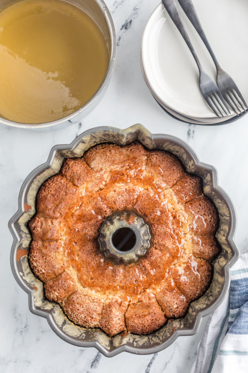 half of the rum glaze poured over warm honey pound cake in the bundt pan