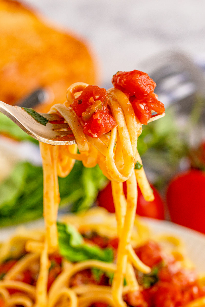 forkful of linguine with tomato basil pasta sauce