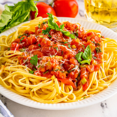 square image of tomato basil pasta sauce served over cooked pasta
