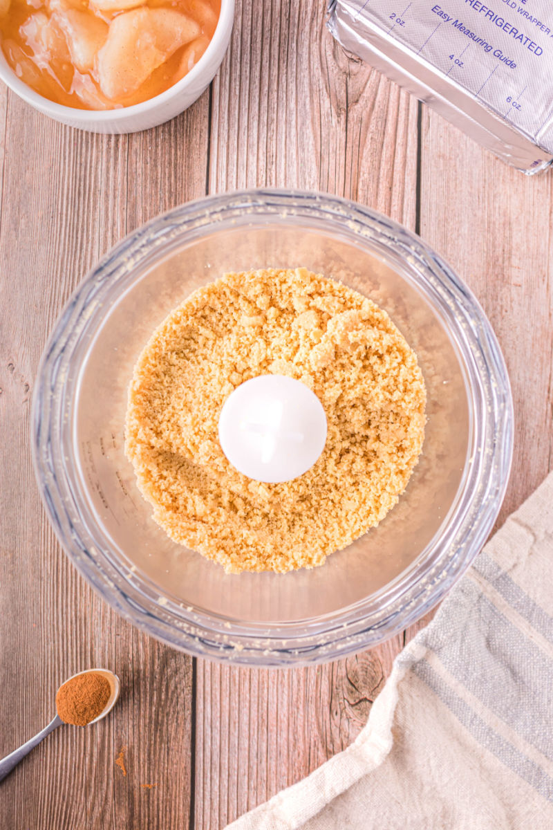 golden oreo crumbs in a food processor bowl