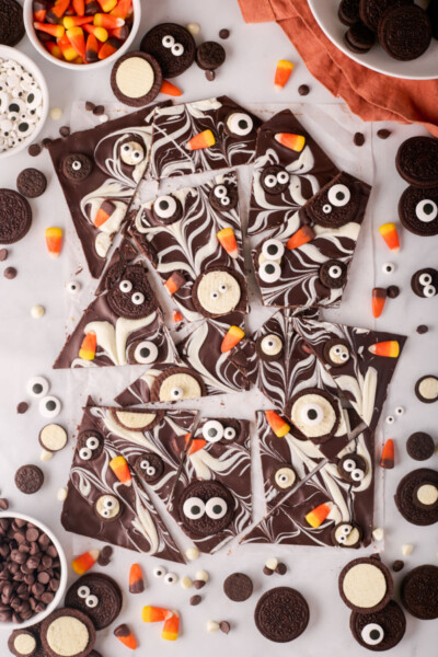 Halloween chocolate bark surrounded by candy corn, oreos, and candy eyes