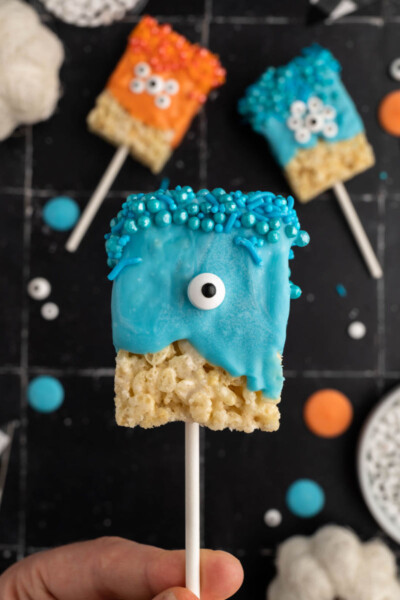 close up of a hand holding a blue monster rice krispie treats