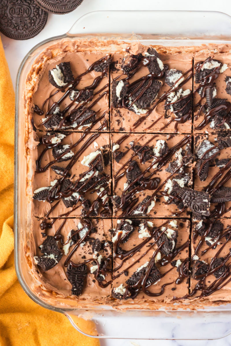 no bake chocolate cheesecake bars cut into 9 squares in the pan