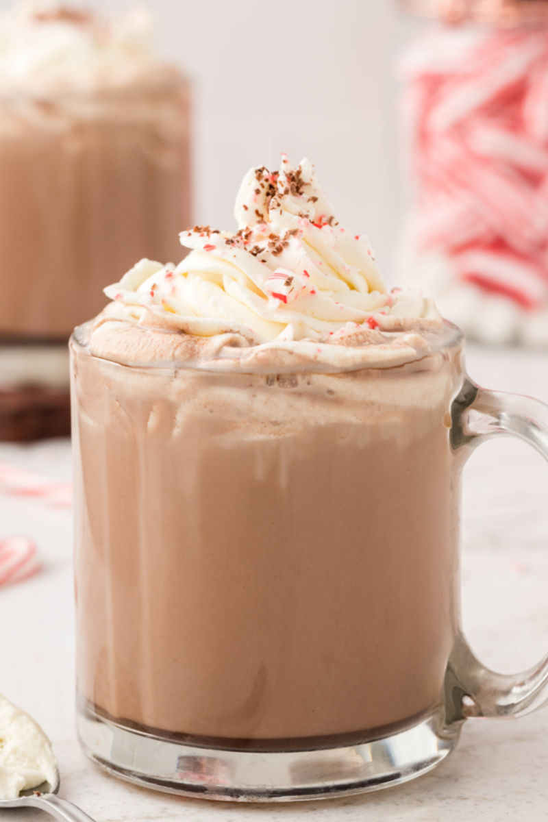 close up of a peppermint mocha topped with whipped cream, peppermint, and chocolate