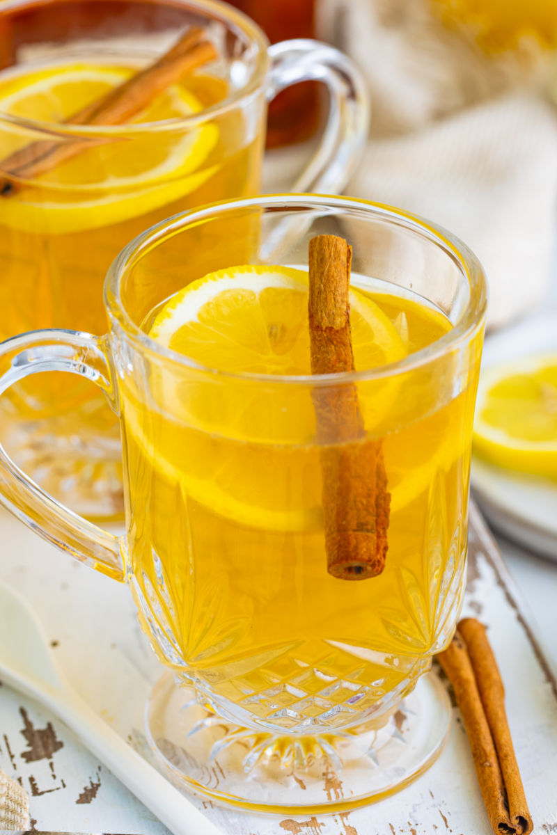 close up of a hot toddy with a lemon slice and cinnamon stick