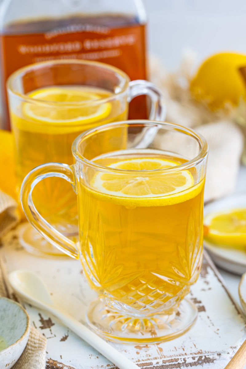 two hot toddies in glass mugs with lemon slices