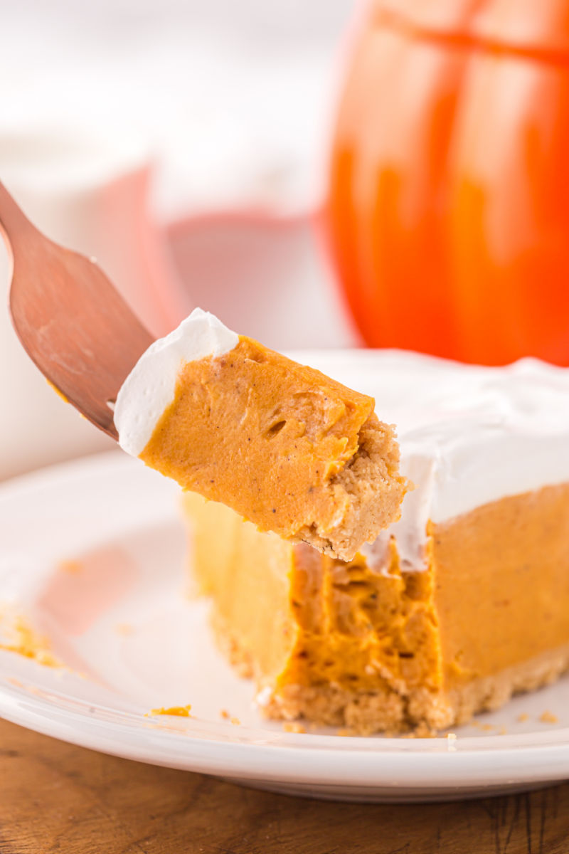 bite of no bake pumpkin pie on a fork over the pie