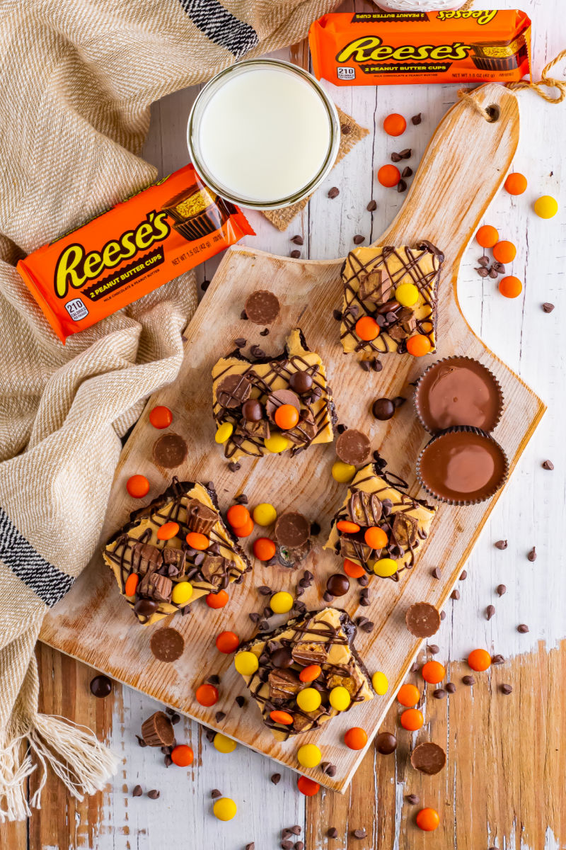 looking down at reese's peanut butter brownies on a wooden board